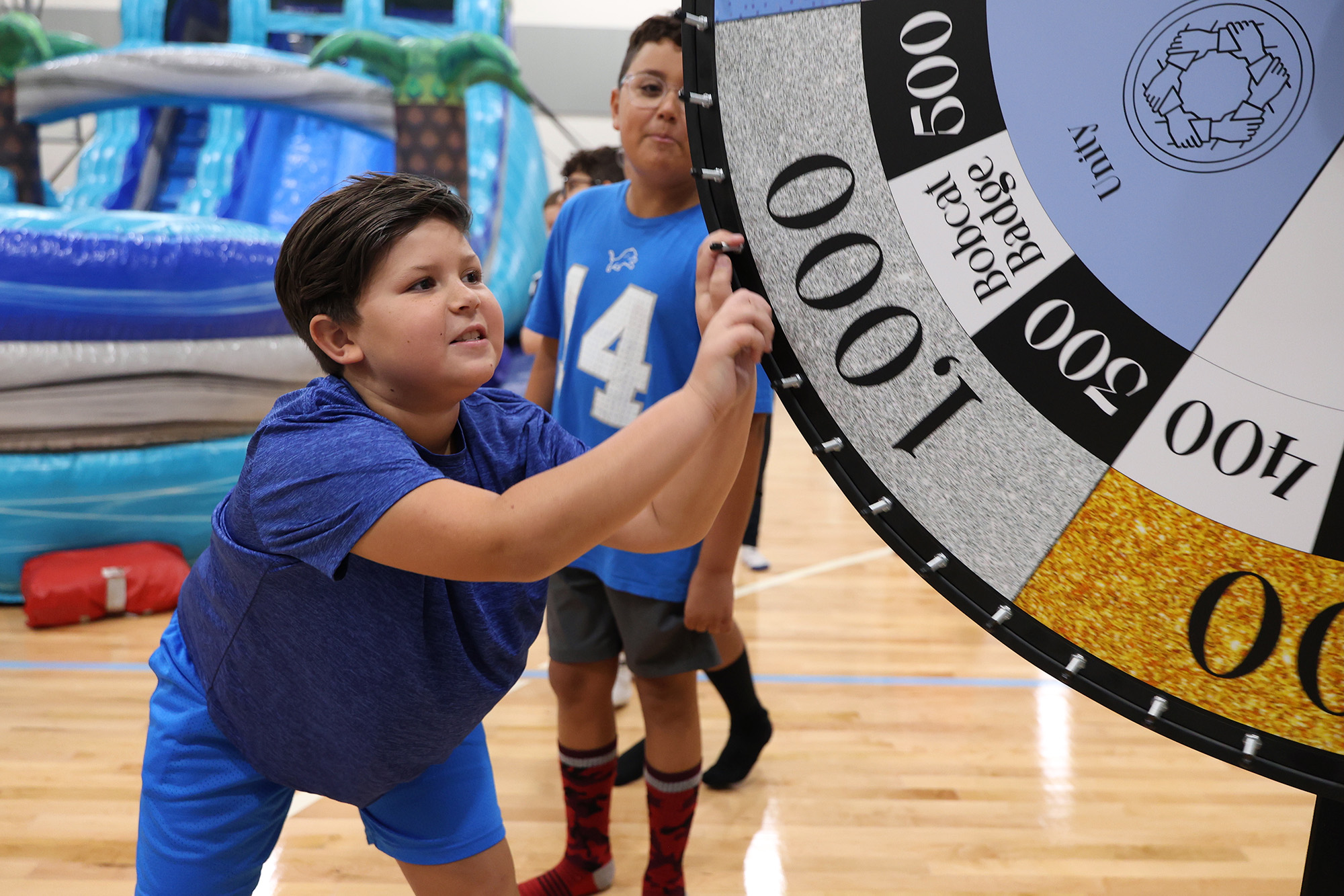 student spinning the wheel - <p>Our students had an amazing time being sorted into houses the first week of school!</p>