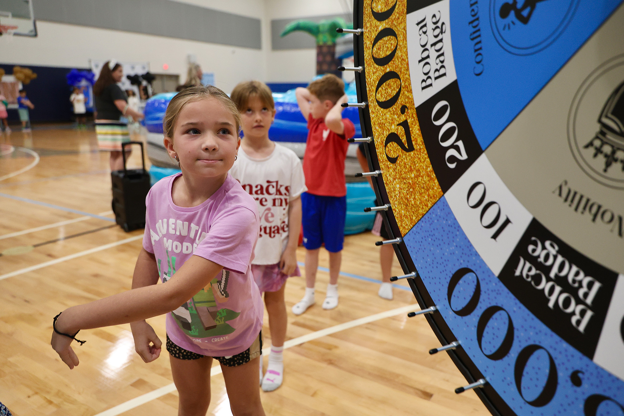 student spinning the wheel - <p>Our students had an amazing time being sorted into houses the first week of school!</p>