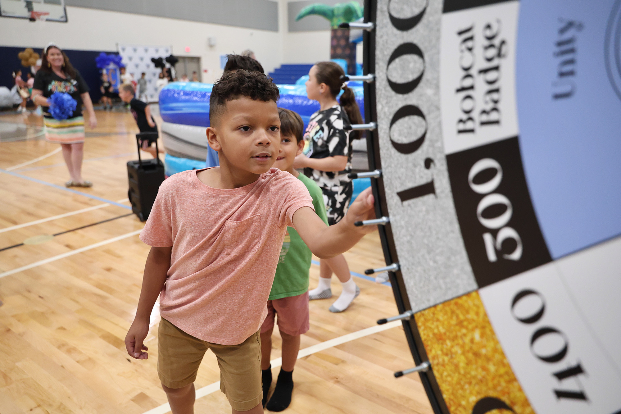 student spinning the wheel - <p>Our students had an amazing time being sorted into houses the first week of school!</p>